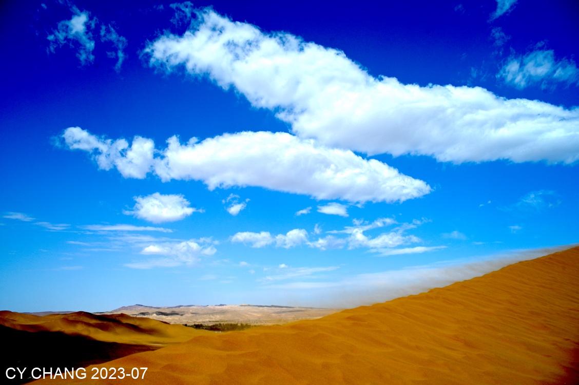 Blue sky, white clouds, sand fog